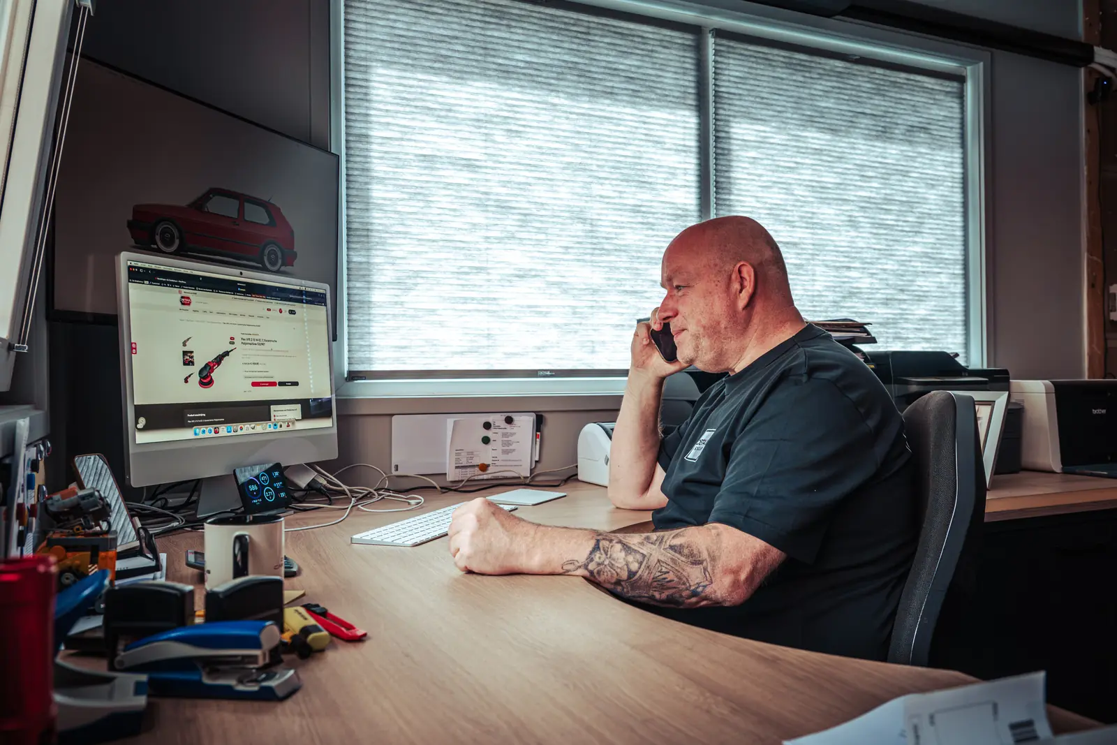 Chris beantwoordt een vraag aan de telefoon achter de webshop